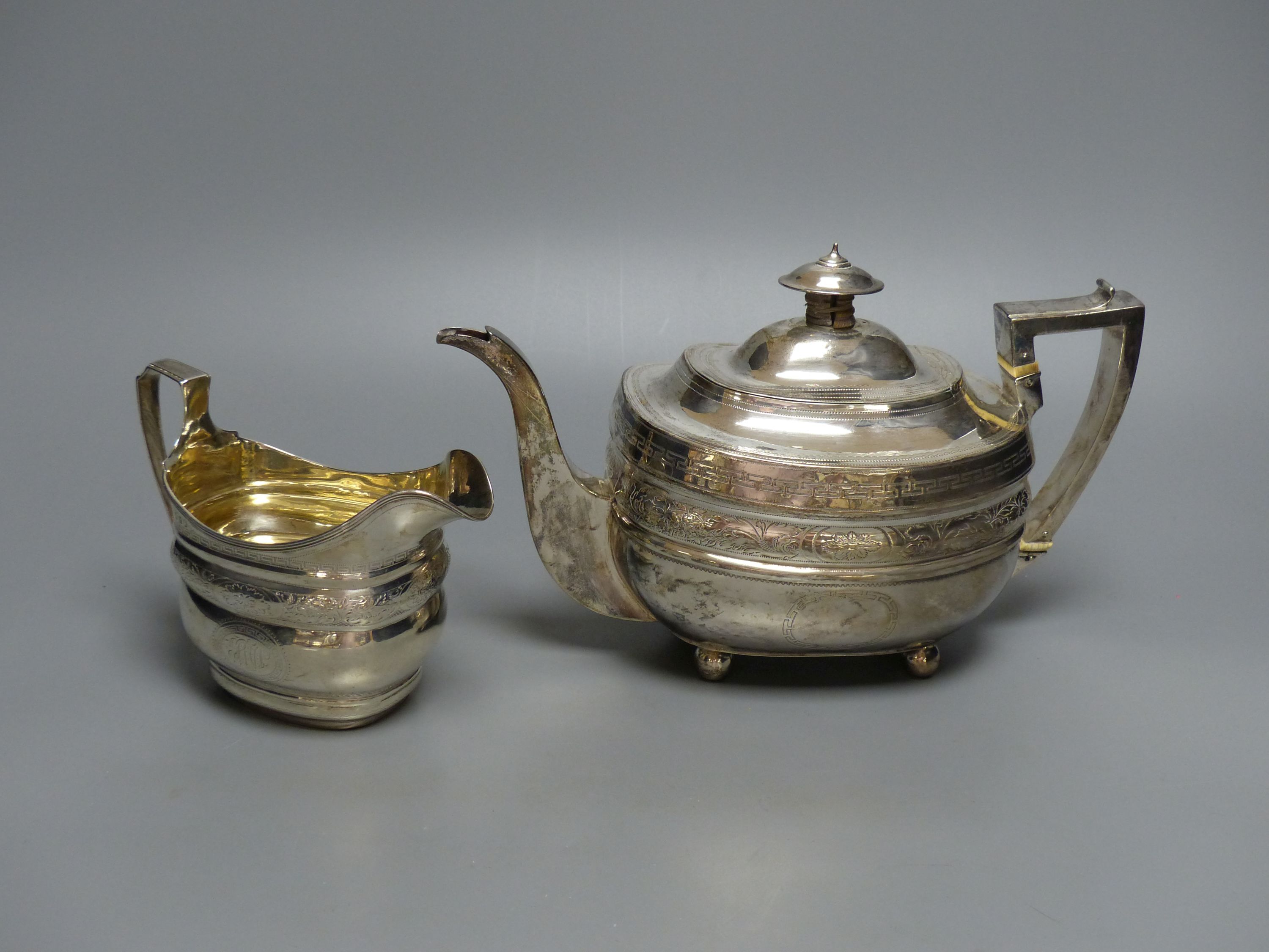 A George III silver teapot and matching cream jug, Urquhart & Hart, London, 1805/1807,